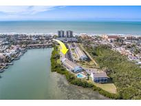 Aerial view of waterfront property, showing community pool and ocean access at 905 Hidden Harbour Dr, Indian Rocks Beach, FL 33785