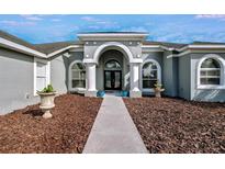 Walkway to the house entrance with landscaping at 9413 Swift Creek Cir, Dover, FL 33527