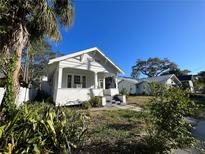 Charming white bungalow home with a spacious front porch at 1105 W De Leon St, Tampa, FL 33606
