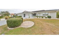 Attractive single-story home with well-manicured lawn and landscaping at 1601 Woodmar Dr, Sun City Center, FL 33573