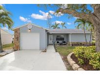 Newly painted house with a landscaped yard and driveway at 4084 Lake Blvd, Clearwater, FL 33762