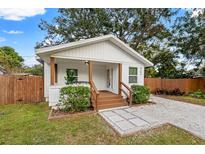 Charming white cottage with brown accents and a welcoming front porch at 6297 29Th N St, St Petersburg, FL 33702