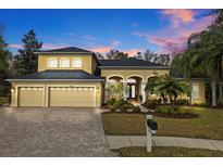 Beautiful two-story house with three-car garage and landscaped yard at 7153 Woods Bay Ct, Land O Lakes, FL 34637