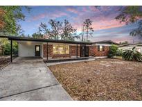 Brick ranch house with carport, landscaping, and a spacious yard at 929 Skyview Dr, Brandon, FL 33510