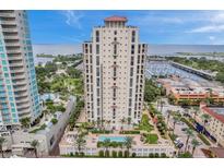 Aerial view of a luxury high-rise building with pool and waterfront views at 100 Beach Ne Dr # 1002, St Petersburg, FL 33701