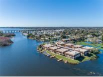 Aerial view of waterfront condo community, showcasing buildings and boat docks at 10172 Seminole Island Dr, Largo, FL 33773