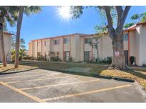 Exterior view of a condo building with parking lot and landscaping at 1620 58Th S Ave # 3, St Petersburg, FL 33712