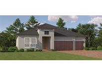 Two-story home with three-car garage, and a beautifully landscaped lawn at 31537 Cardinal Yard Dr, San Antonio, FL 33576