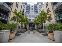 Building entrance with lush landscaping and palm trees at 400 4Th S Ave # 506, St Petersburg, FL 33701