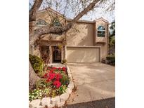 Tan two-story townhome with attached garage and landscaped garden at 661 Segovia Ne Ct, St Petersburg, FL 33703
