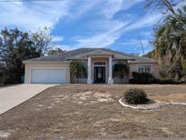Single-story home with attached garage and landscaping at 2365 Ardenwood Dr, Spring Hill, FL 34609