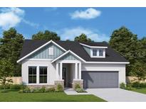 Two-story home with gray siding, stone accents, and a two-car garage at 5289 Everlong Dr, Apollo Beach, FL 33572