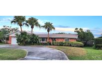 Brick home with palm trees, driveway, and landscaped yard at 6773 14Th N Ave, St Petersburg, FL 33710