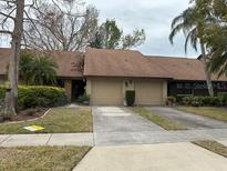 Attractive exterior of a two-unit condo building with a well-maintained landscape at 9760 Lake Seminole E Dr, Largo, FL 33773