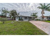 Cute bungalow with brick paver driveway and well-manicured lawn at 3645 Lokai Pl, Sarasota, FL 34232