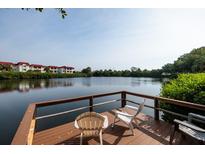 Relaxing waterfront dock with chairs, offering peaceful lake views at 4550 Overlook Ne Dr # 258, St Petersburg, FL 33703