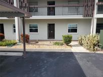 Condo building exterior with parking and landscaping at 5197 Silent Loop # 121, New Port Richey, FL 34652