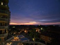 Stunning sunset view over water, with luxury condos and palm trees below at 555 5Th Ne Ave # 521, St Petersburg, FL 33701