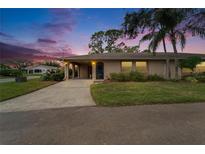 Inviting home exterior showcasing a landscaped front yard and a charming entryway at 1111 Harefield Cir # 62, Sun City Center, FL 33573