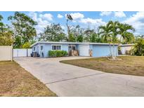 Charming light blue house with a well-maintained lawn and driveway at 5715 20Th W St, Bradenton, FL 34207