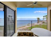 Enjoy the coastal scenery from this condo's balcony, overlooking the ocean and palm trees at 6322 Palma Del Mar S Blvd # 209, St Petersburg, FL 33715