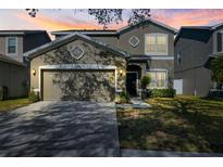 Two-story house with a two-car garage and landscaped lawn at 12509 Bay Branch Ct, Tampa, FL 33635