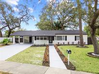 Newly renovated home with carport and landscaped lawn at 210 W Floriland Ave, Tampa, FL 33612