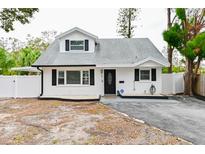 Charming white brick ranch house with gray roof and well-manicured lawn at 5816 Woodrow Wilson Ne Blvd, St Petersburg, FL 33703