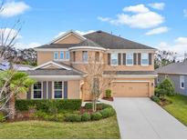 Beautiful two-story home featuring manicured lawn and attached two-car garage at 6307 Brevada Ln, Apollo Beach, FL 33572