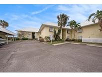 Front view of condo building, showing parking and landscaping at 7300 Sunshine Skyway S Ln # 108, St Petersburg, FL 33711