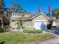 Two-story house with a two-car garage and landscaped lawn at 8811 Casablanca Way # 106, Tampa, FL 33626