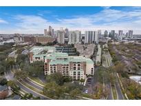 Aerial view of condo building with city skyline, tennis courts, and landscaping at 1002 S Harbour Island Blvd # 1502, Tampa, FL 33602