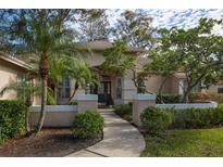 Inviting home exterior featuring a landscaped walkway and lush greenery at 16809 Woburn Ln, Lutz, FL 33549