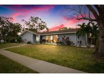 Beautiful home exterior at dusk with landscaping and a well-maintained lawn at 3006 Mockingbird Ct, Clearwater, FL 33762