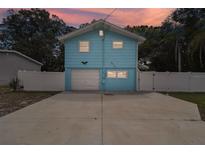 Light blue house with a white fence and driveway at 6416 Finance Ave, Weeki Wachee, FL 34607