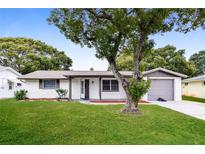 Charming single story home with mature landscaping and a two car garage at 7930 Datura Lane Ln, New Port Richey, FL 34653