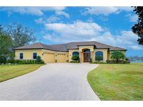 Beautiful one-story home with a three-car garage and paver driveway at 10929 Brooksnest Ct, Lithia, FL 33547