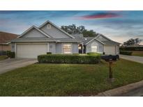 Gray house with two car garage and well-manicured lawn at 3624 Muirfield Ct, New Port Richey, FL 34655