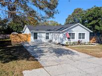 Newly renovated home with landscaped yard and driveway at 6811 S Himes Ave, Tampa, FL 33611