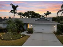 Well-maintained house with a landscaped yard, driveway, and two-car garage at 3104 Ashwood Ln, Safety Harbor, FL 34695