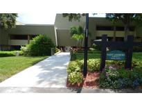 Saint Andrews Lodge 23 building exterior with landscaping and walkway at 36750 Us Highway 19 N # 23120, Palm Harbor, FL 34684