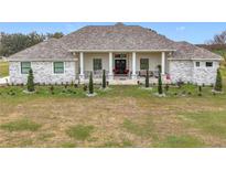 Stunning ranch home with stone accents and a large covered porch at 8459 Harvey Walden Dr, Plant City, FL 33565