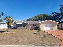 Updated single story home with a large driveway and mature landscaping at 10202 Oak Hill Dr, Port Richey, FL 34668