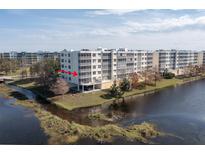 Aerial view of condo building near lake at 1200 Country Club Dr # 6206, Largo, FL 33771