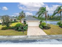 Single-story home with a paved driveway and landscaped lawn at 1950 Sterling Glen Ct, Sun City Center, FL 33573