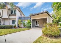 Front view of charming condo with carport and well-manicured landscaping at 2650 Barksdale Ct # 0, Clearwater, FL 33761