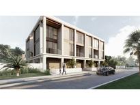 Modern three-story home with light-colored facade and a sleek design at 2707 N Woodrow Ave # 3, Tampa, FL 33602