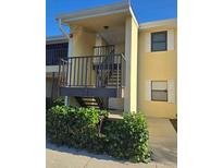 Condo building exterior featuring a stairway and landscaping at 3001 58Th S Ave # 203, St Petersburg, FL 33712