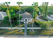 House with a walkway, surrounded by lush tropical landscaping and palm trees at 4056 18Th S Ave, St Petersburg, FL 33711