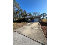 Charming one-story home with a driveway and well-lit front porch at 530 62Nd S Ave, St Petersburg, FL 33704